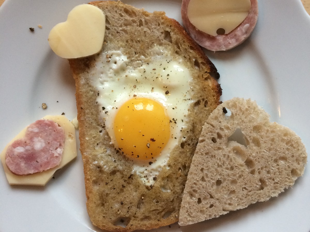 Heart shaped egg on the pan